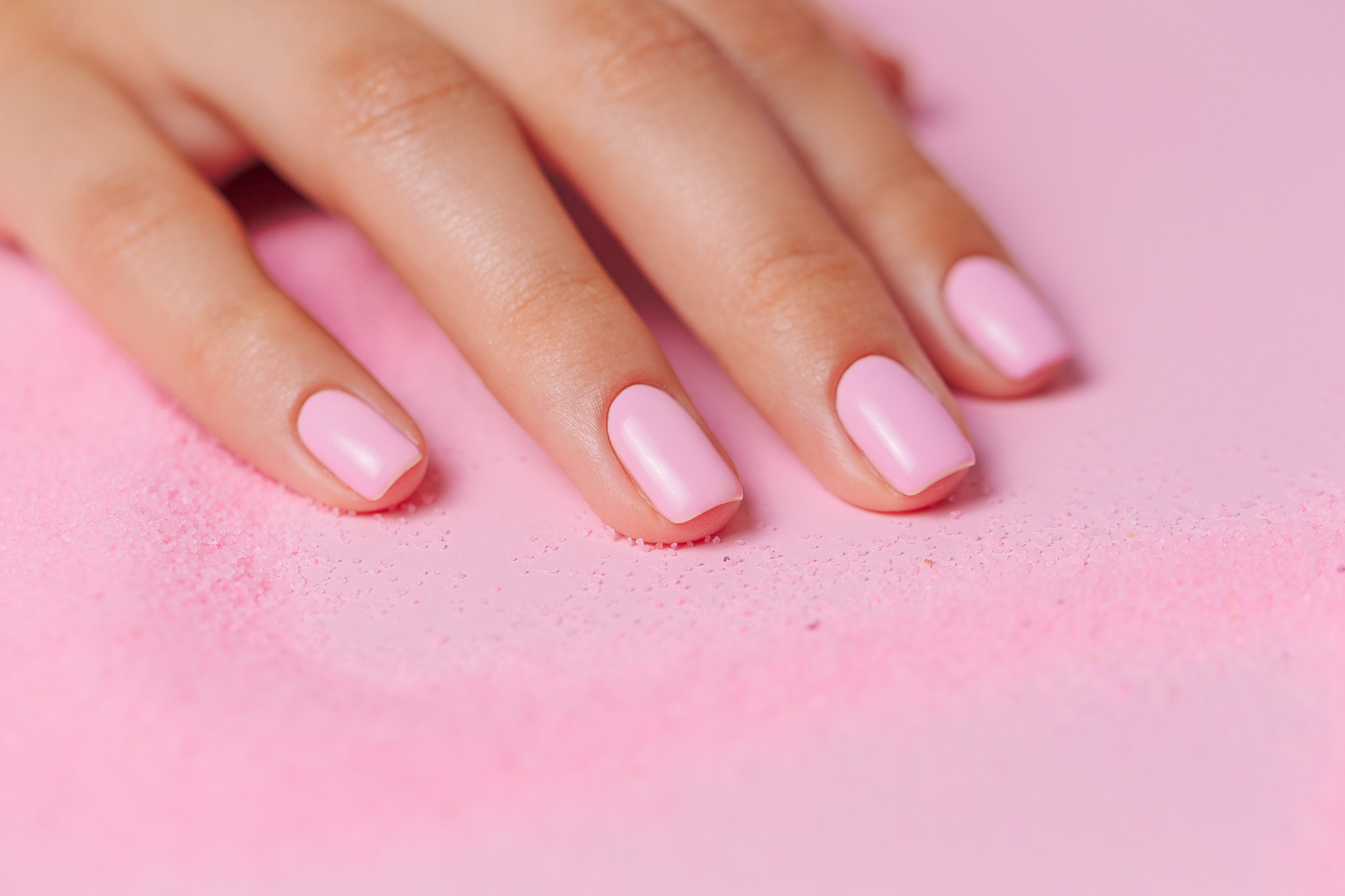 Hand on a Surface with a Trail of Pink Powder  